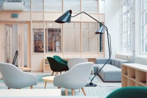 Office space with wood and light grey furniture 